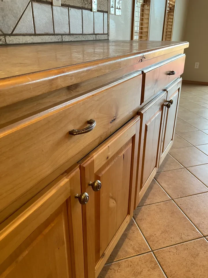 Warm wood kitchen cabinetry and countertop detail