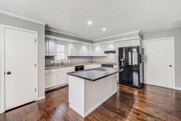 Modern kitchen with white cabinets and island